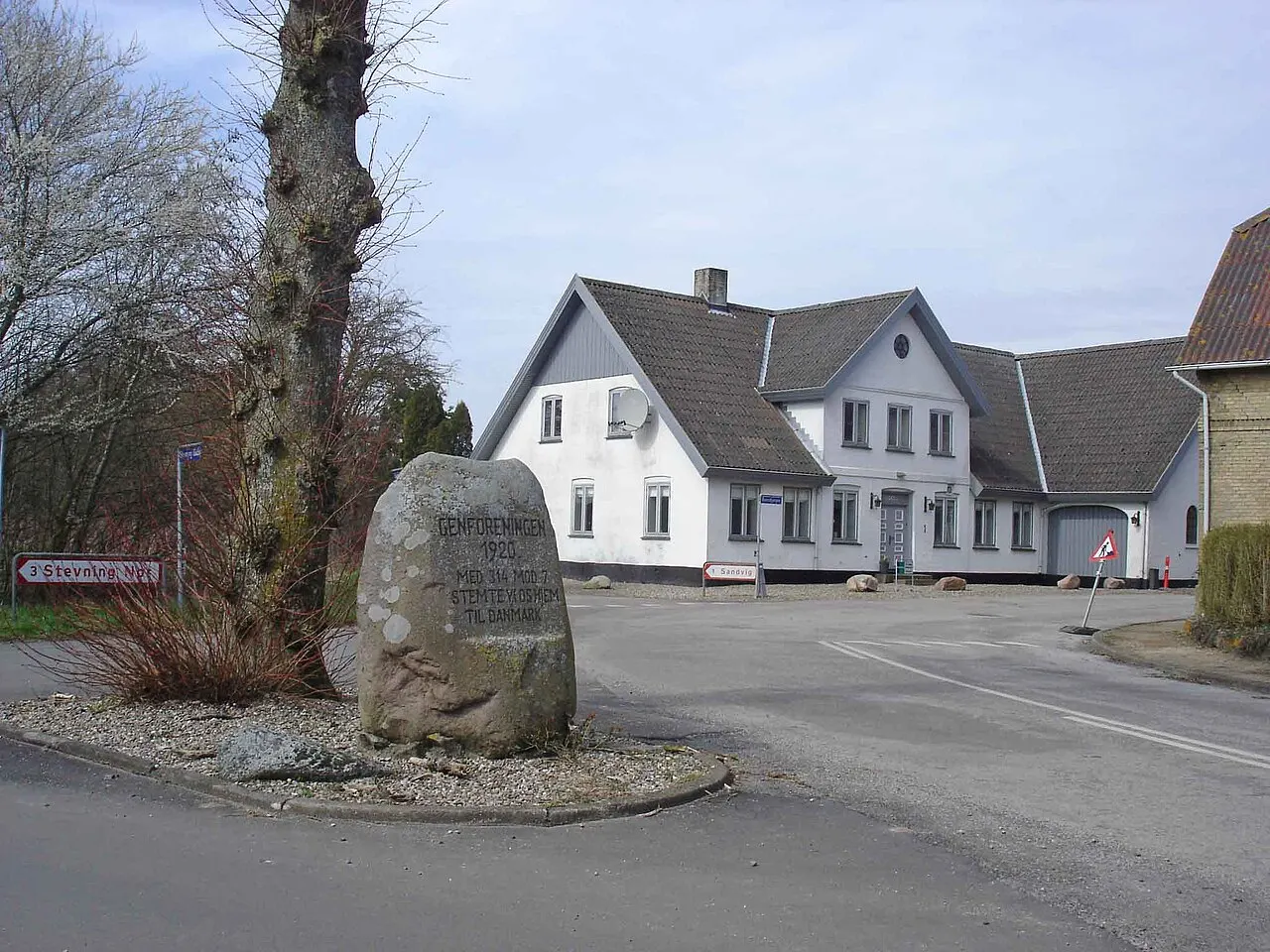 Genforeningssten i Stevning, som i 1920 stemte sig hjem til Danmark med 314 mod 7 stemmer. I baggrunden Hans Hansens kro og købmandsbutik…